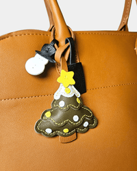 Brown leather bag with Christmas tree and snowman charms.