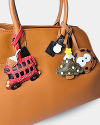 Brown handbag with decorative charms.