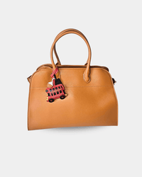 Brown handbag with a London bus charm.