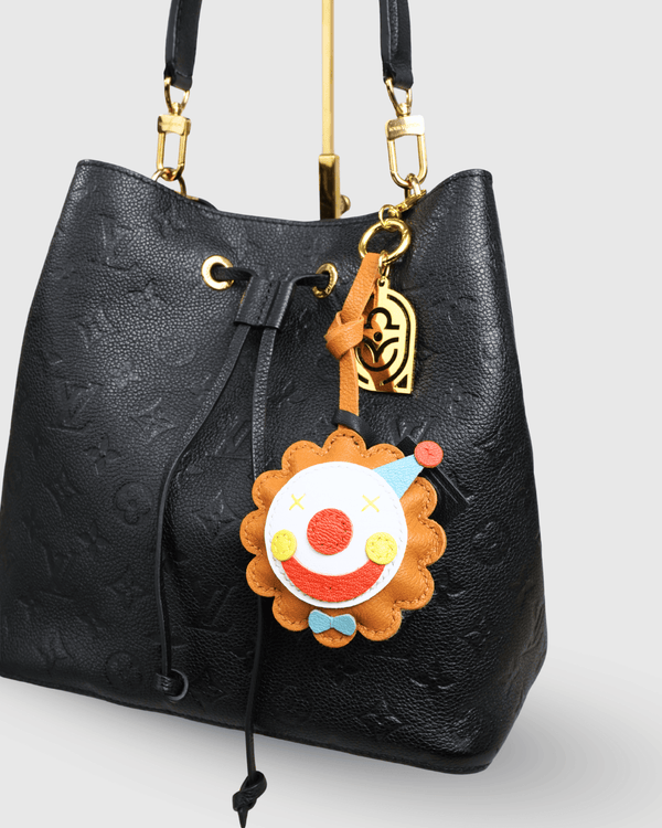 Louis Vuitton black handbag with clown charm