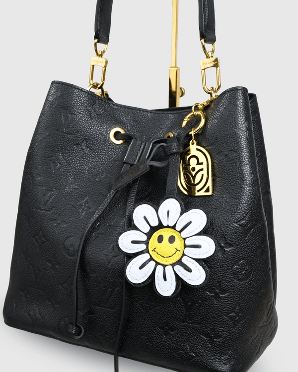 Black Louis Vuitton bucket bag with daisy charm