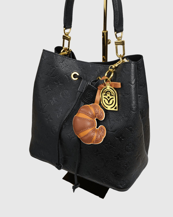 Louis Vuitton black bucket bag with croissant charm