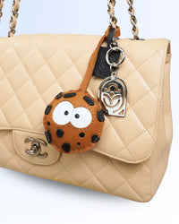 Cookie shaped goatskin leather bag charm on luxury handbag