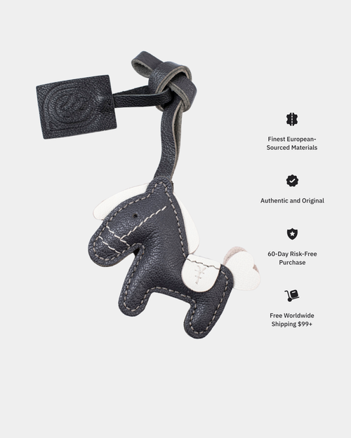 Gray leather keychain shaped like a horse on a white background with promotional text.