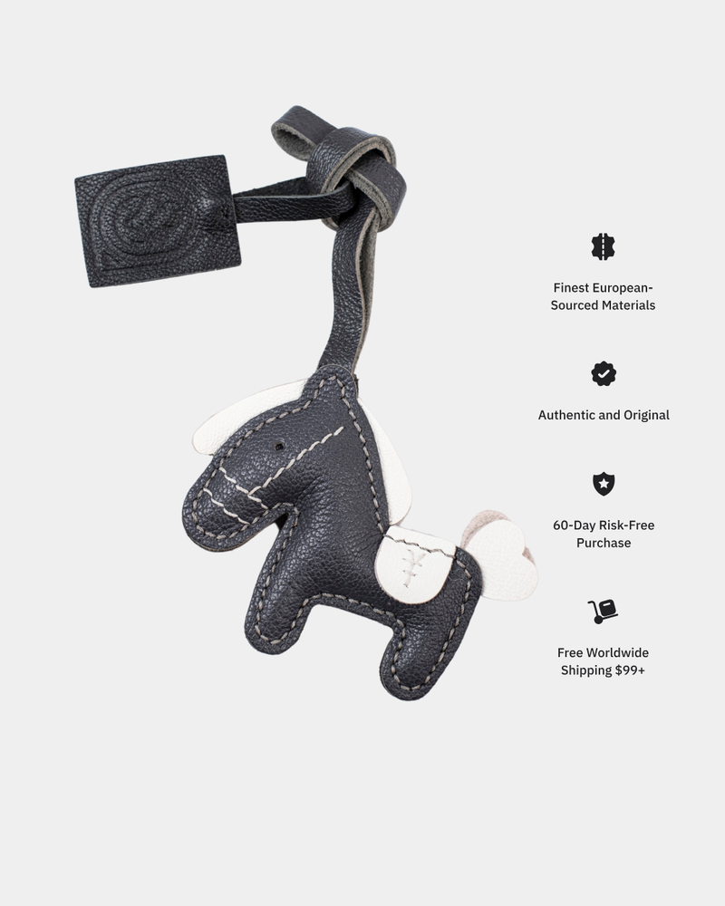 Gray leather keychain shaped like a horse on a white background with promotional text.