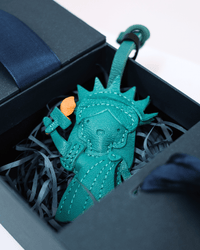 Turquoise keychain in a box with blue interior