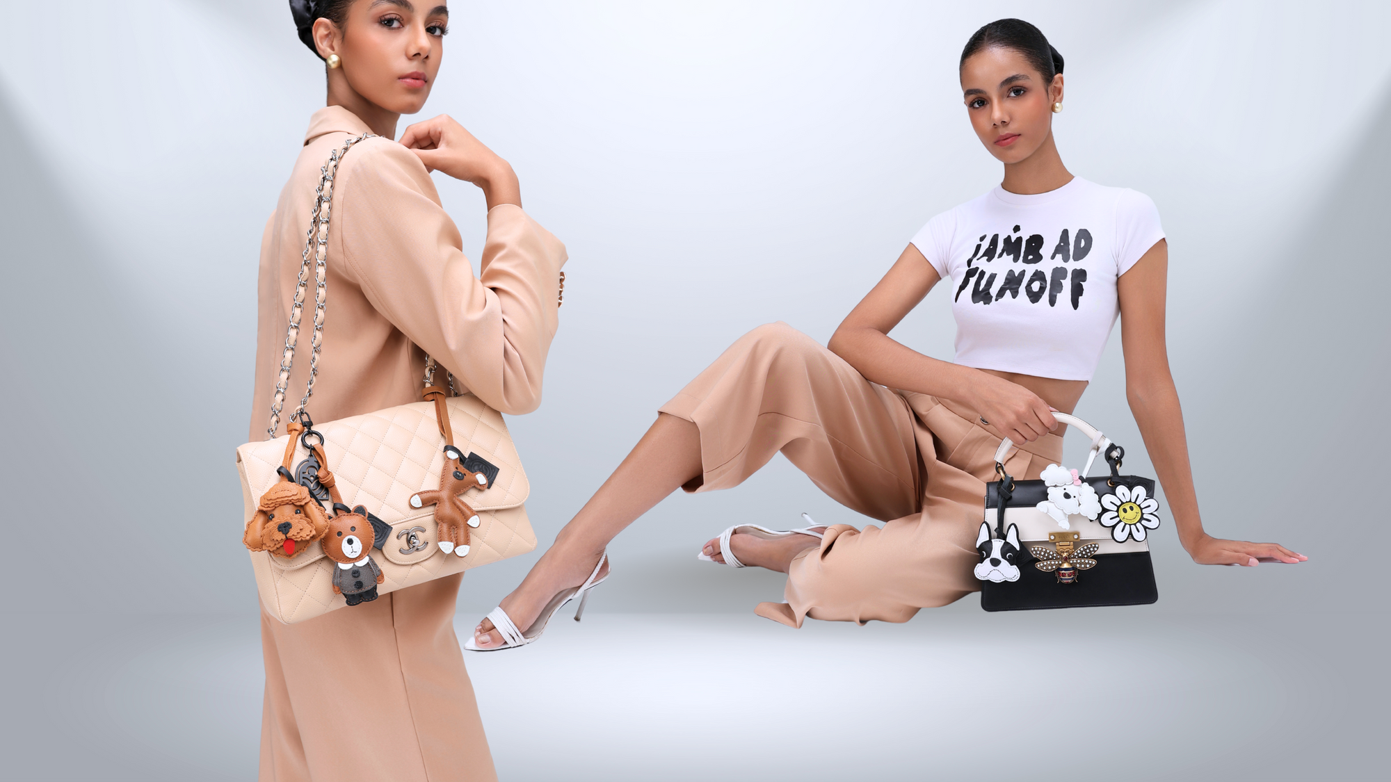 Model with luxury handbags with leather bag charms on a plain background