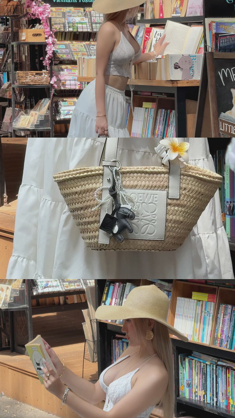 video of a stylish girl in summer outfit posing with loewe bag and grey horse premium leather bag charm