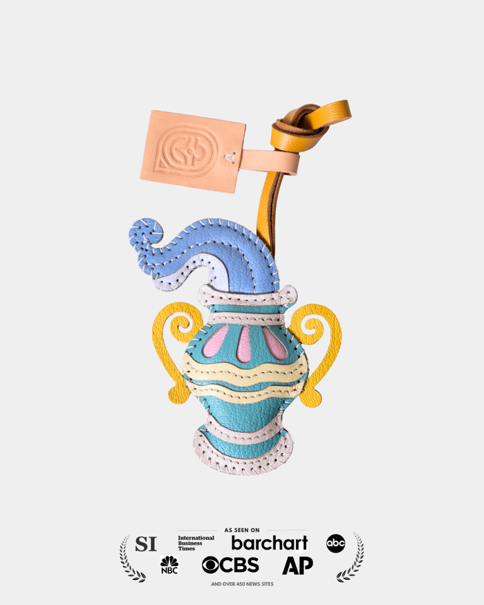 Colorful decorative urn with a pink label on a white background