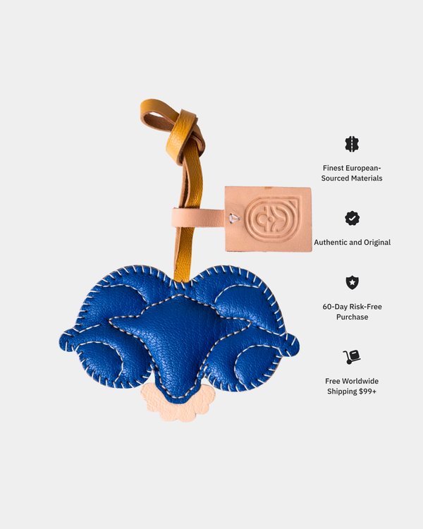 Blue leather keychain with a strap on a light gray background