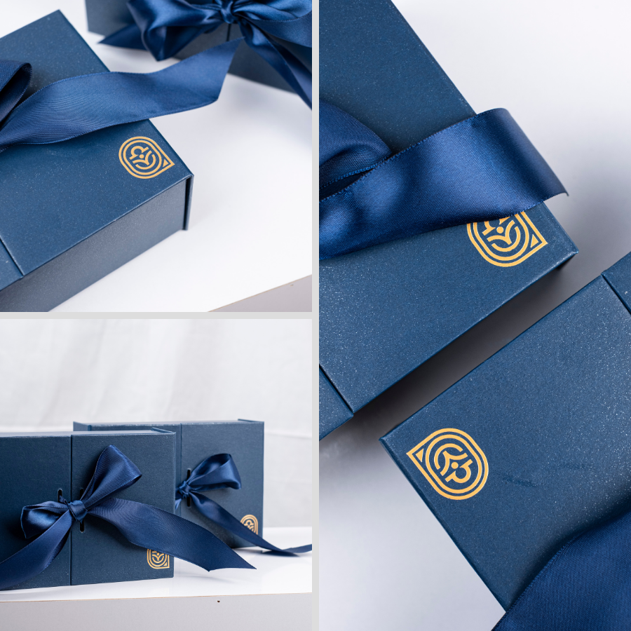 premium gift box with blue ribbon and the q charm gold stamping logo