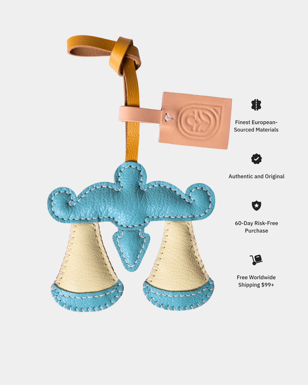 Blue and beige leather product with a brown strap on a white background