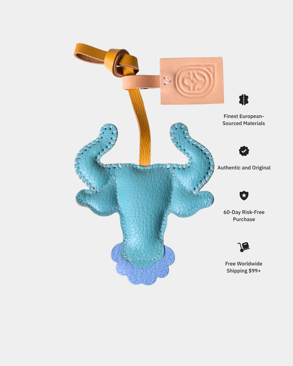 Blue plush toy with a leather strap on a white background