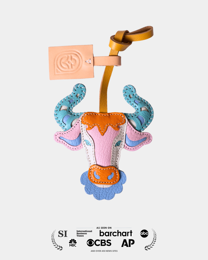 Colorful toy with a cup and animal ears on a white background